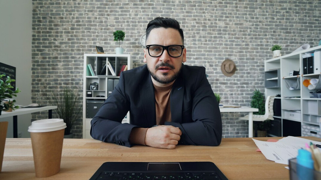 man in suit at desk